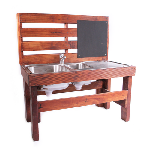 Wooden mud kitchen with silver sink and black chalkboard attached. 